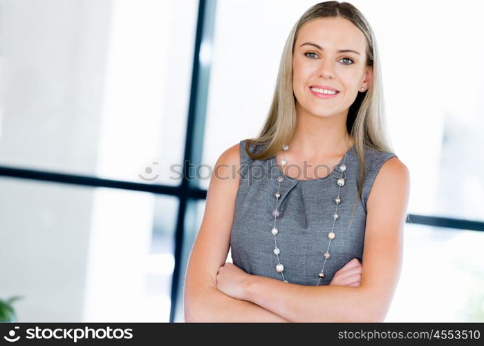 Young businesswoman standing smiling in office