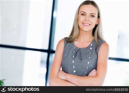 Young businesswoman standing smiling in office