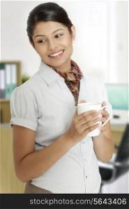 Young businesswoman taking a coffee break from her busy schedule