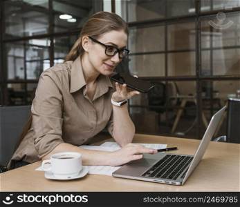 young businesswoman talking phone during meeting