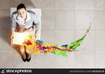 Young businesswoman. Top view of businesswoman sitting in chair and reading book