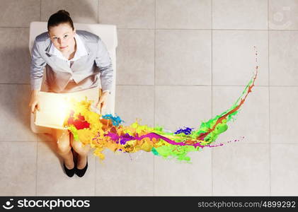 Young businesswoman. Top view of businesswoman sitting in chair and reading book