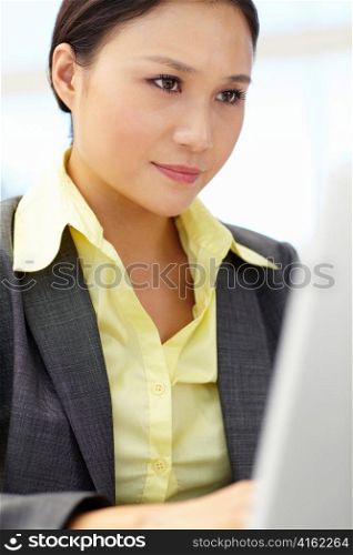 Young businesswoman using laptop
