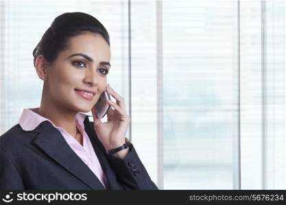 Young businesswoman using mobile phone in office