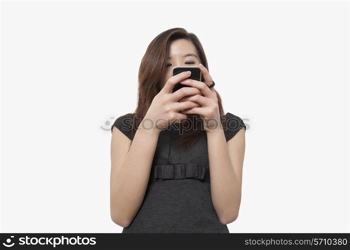 Young businesswoman using smart phone over white background
