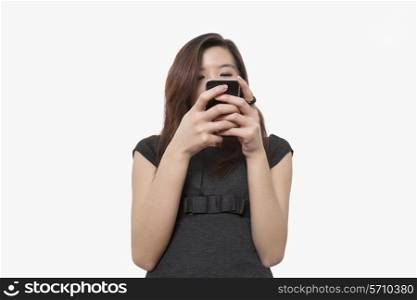 Young businesswoman using smart phone over white background
