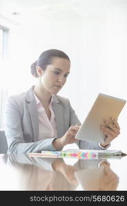 Young businesswoman using tablet PC in office