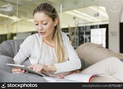 Young businesswoman using tablet PC in office