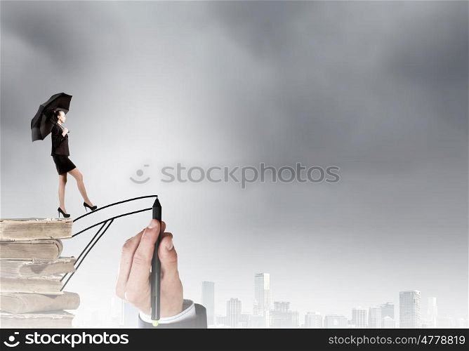 Young businesswoman walking on hand drawn bridge