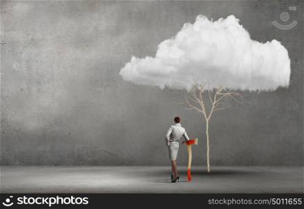 Young businesswoman with axe and cloud tree. Deforestation problem