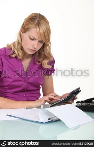 young businesswoman with calculator looking concentrated