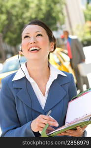 Young businesswoman with diary, laughing