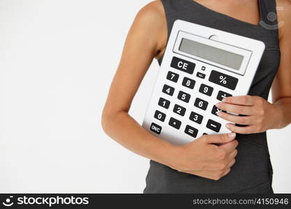 Young businesswoman with giant calculator