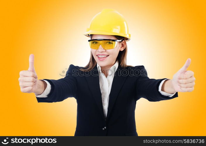 Young businesswoman with hard hat on white