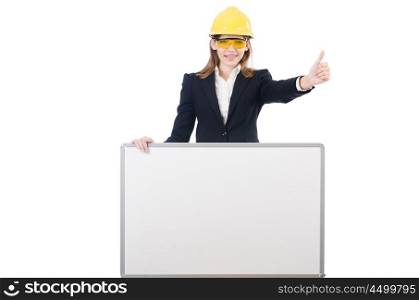 Young businesswoman with hard hatand blank board isolated on white