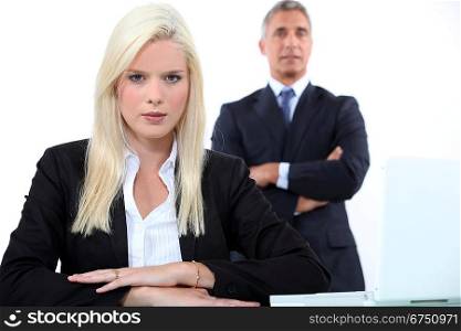 Young businesswoman with older male colleague