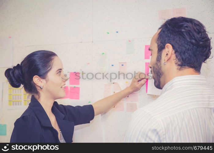 young businesswoman with present profit and secretary while giving presentation in office and talking business people other, teamwork concept.