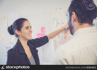 young businesswoman with present profit and secretary while giving presentation in office and talking business people other, teamwork concept.