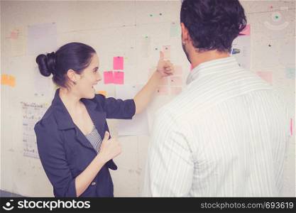 young businesswoman with present profit and secretary while giving presentation in office and talking business people other, teamwork concept.