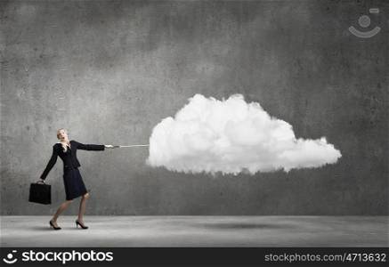 Young businesswoman with suitcase pulling cloud on lead. Cloud computing