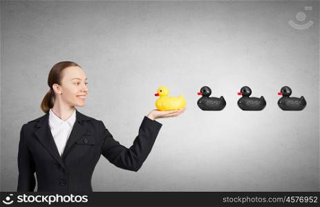Young businesswoman with yellow rubber duck toy. Woman and duck
