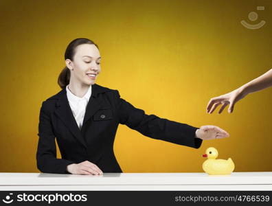 Young businesswoman with yellow rubber duck toy. Woman and duck