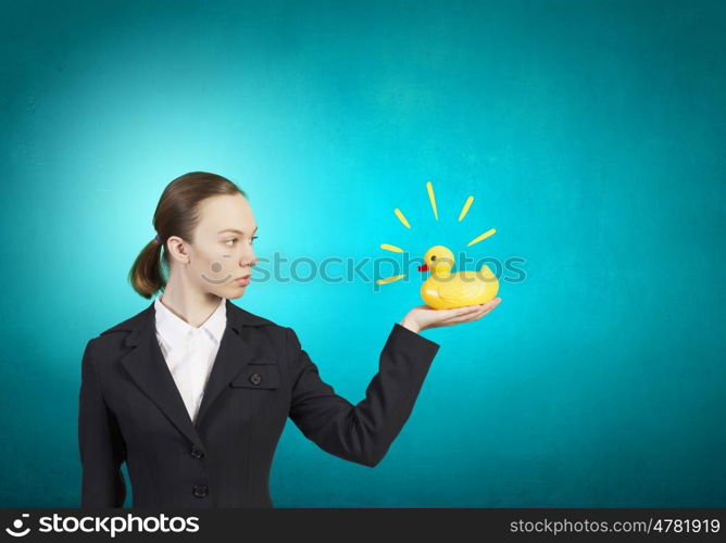 Young businesswoman with yellow rubber duck toy. Woman and duck