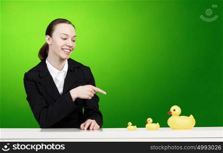 Young businesswoman with yellow rubber duck toy. Woman and duck