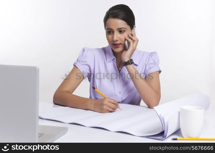 Young businesswoman working at desk over white background