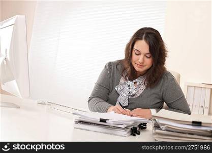 Young businesswoman working at office with computer