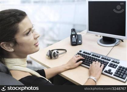 Young businesswoman works on a laptop computer in the modern office.