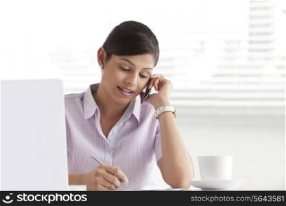 Young businesswoman writing white using cell phone