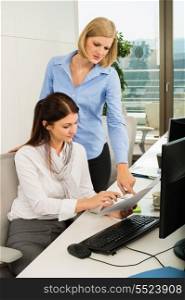Young businesswomen discussing at office desk