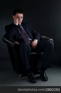 Young bussinessman sitting in black chair