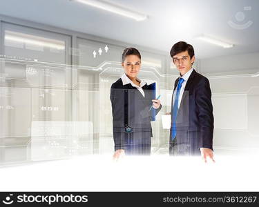 Young busuinesspeople standing against high-tech image background
