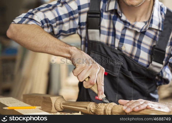 Young carpenter working with cutter in his studio