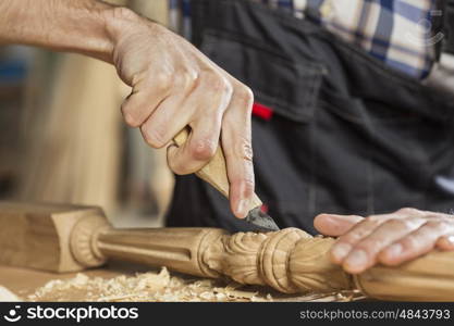 Young carpenter working with cutter in his studio