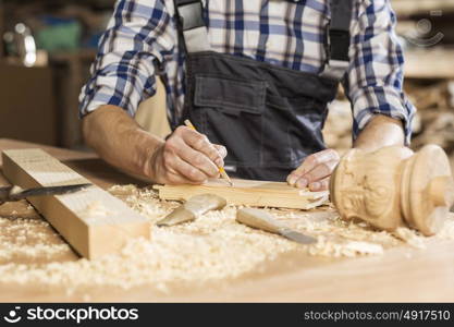 Young carpenter working with cutter in his studio