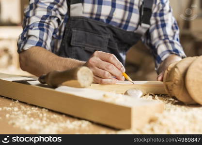 Young carpenter working with cutter in his studio