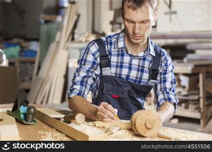Young carpenter working with cutter in his studio. Carpenter at work