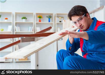 Young carpenter working with wooden planks