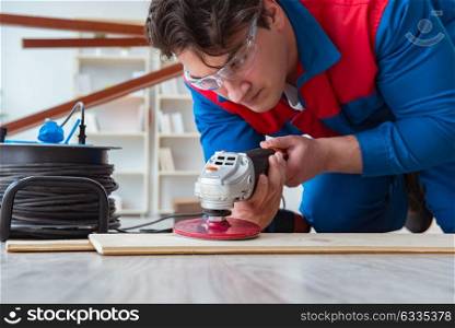 Young carpenter working with wooden planks