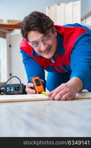 Young carpenter working with wooden planks