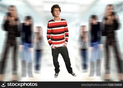 young casual boy full body, among some out of focus people
