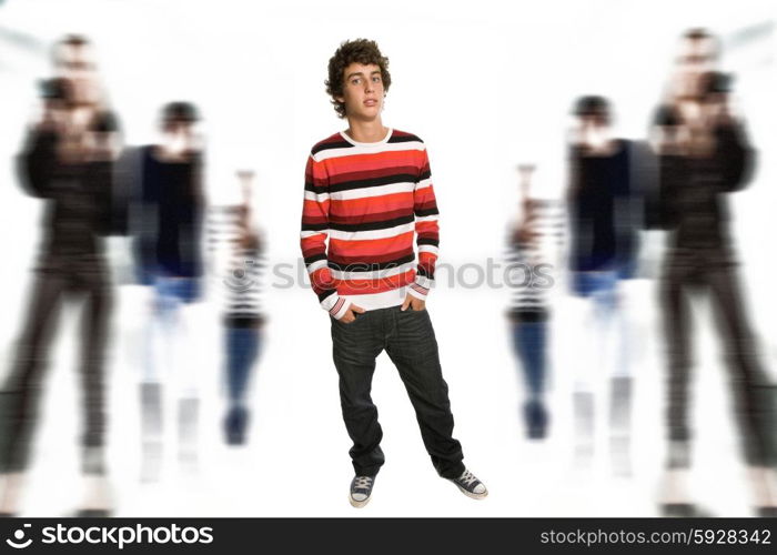 young casual boy full body, among some out of focus people