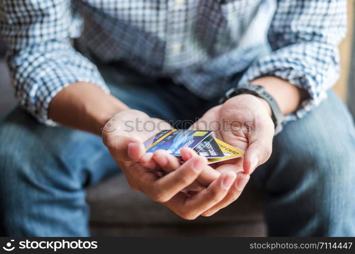Young casual Business man holding credit card for online shopping while making orders in the cafe.business, lifestyle, technology, ecommerce and online payment concept