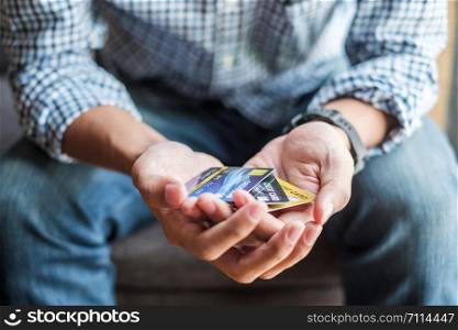 Young casual Business man holding credit card for online shopping while making orders in the cafe.business, lifestyle, technology, ecommerce and online payment concept