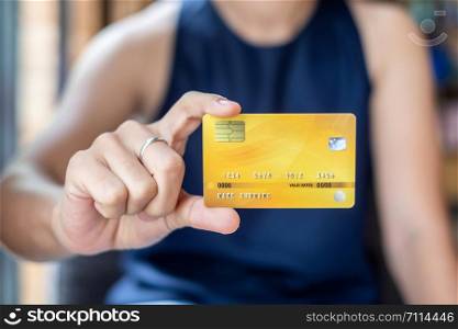 Young casual Business woman holding credit card for online shopping while making orders in the cafe.business, lifestyle,technology,ecommerce and online payment concept