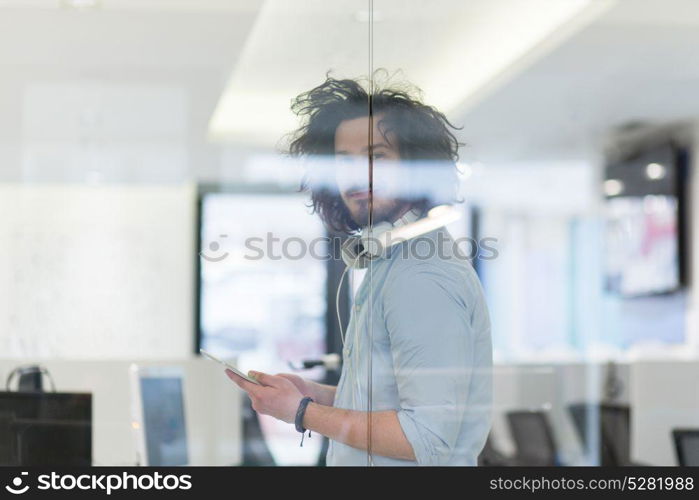 young casual businessman using tablet computer in startup office