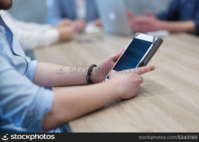 young casual businessman using tablet computer in startup office